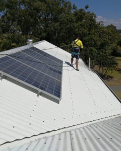 Man Roof Cleaning and wearing Safety Equipment